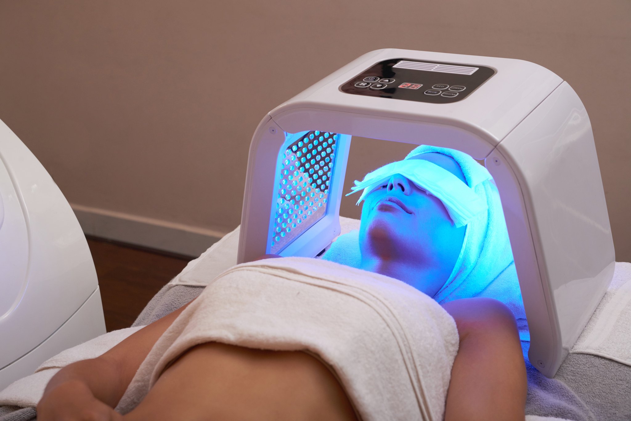 woman has LED light therapy for skin rejuvenation, as part of the VIE AquaFacial