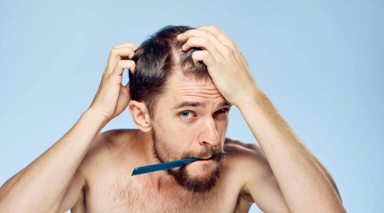 young man noticing early signs of hair loss