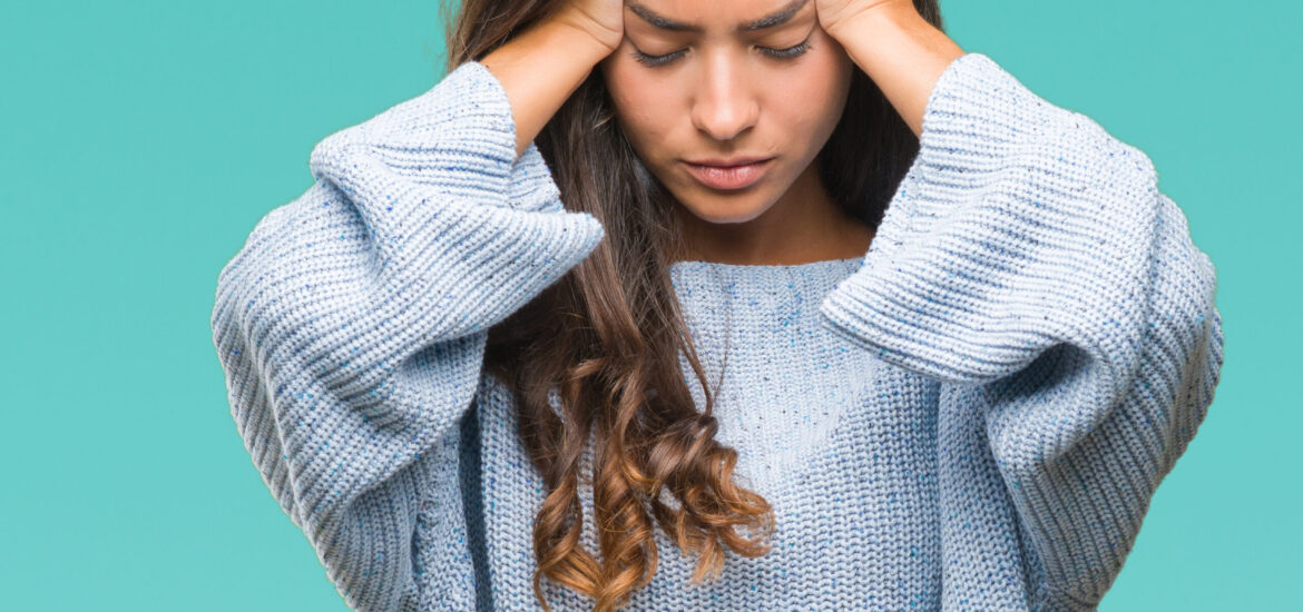 migraine-woman woman suffering from a migraine