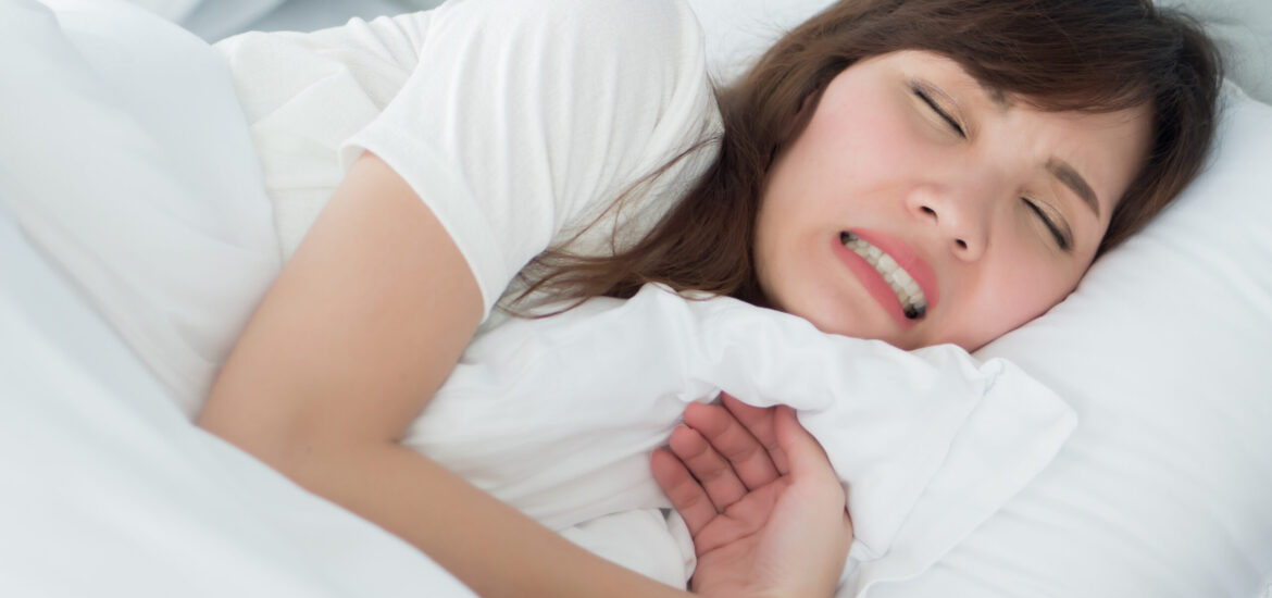 shutterstock_1081692827 woman suffering from bruxism or teeth grinding in her sleep