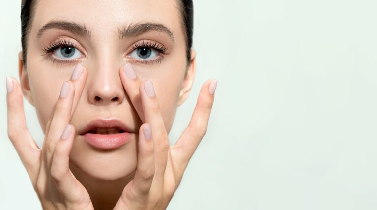 woman demonstrates the benefits of tear trough treatment