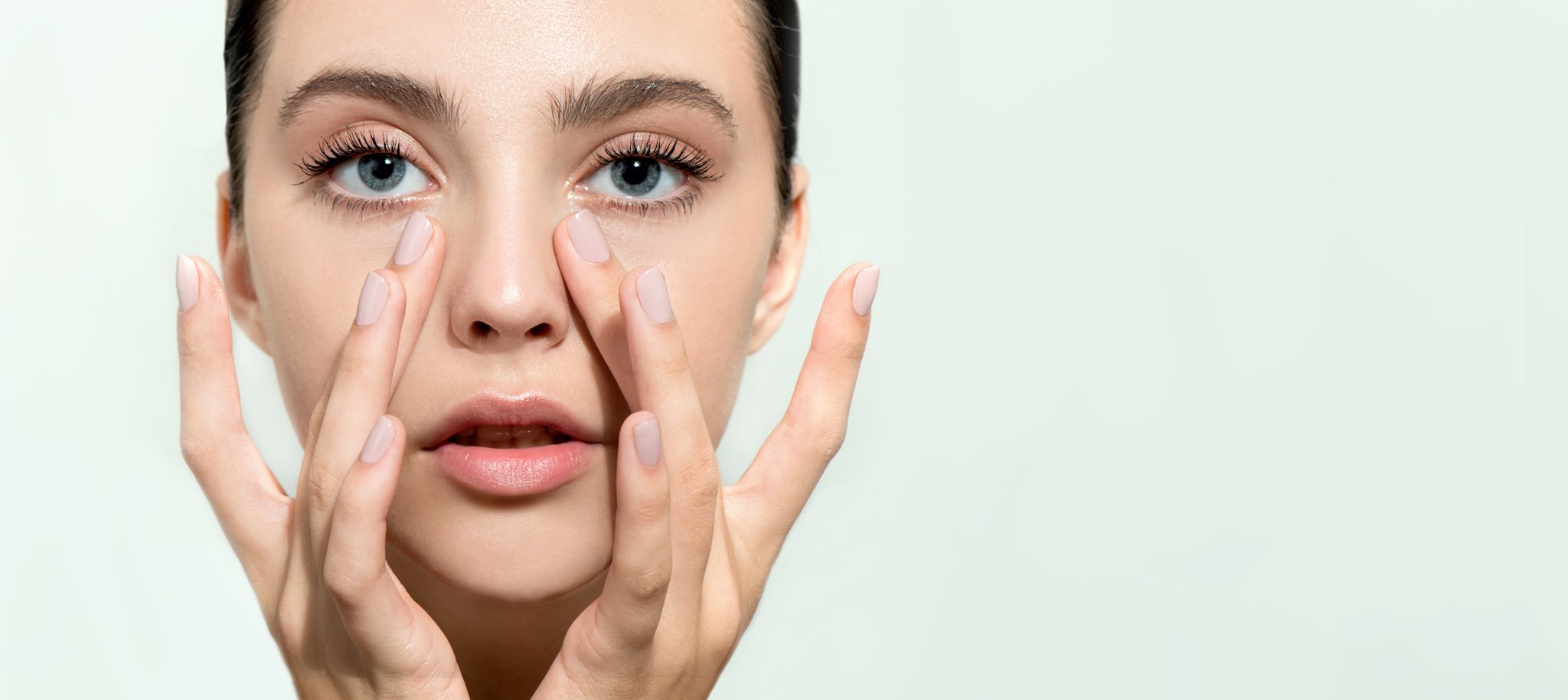 woman demonstrates the benefits of tear trough treatment