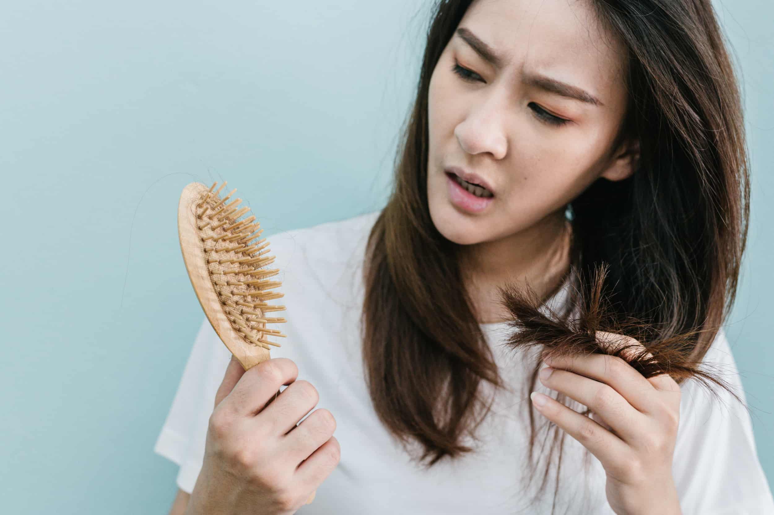 woman wondering what is causing her hair loss