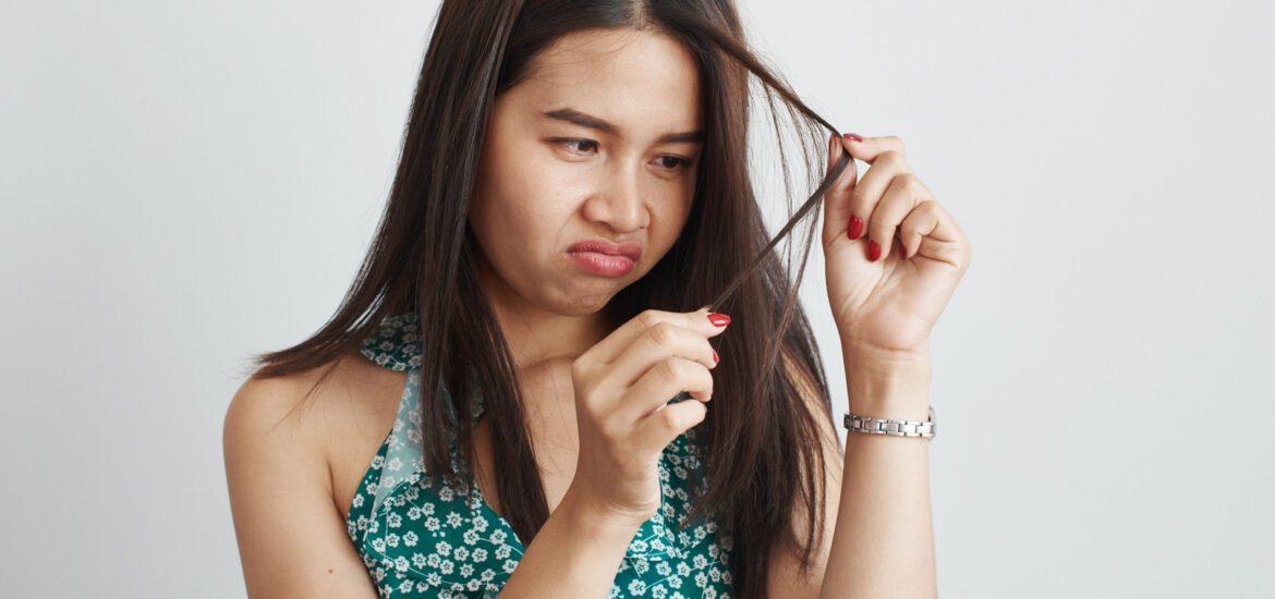 shutterstock_1528783283 woman suffering from dry, thinning and damaged hair