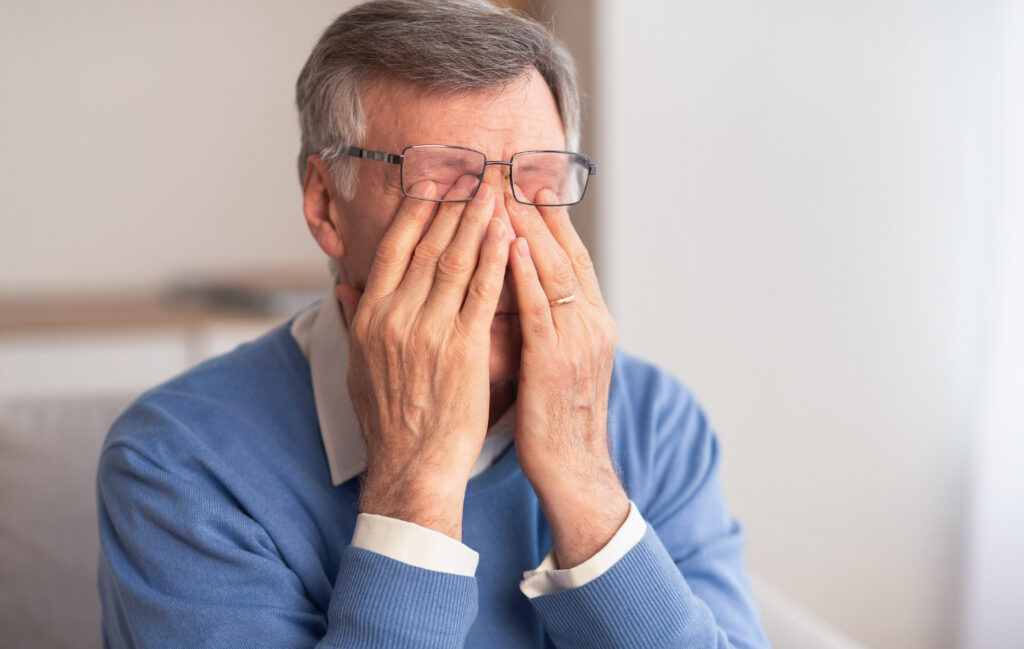 man suffering from migraine with aura