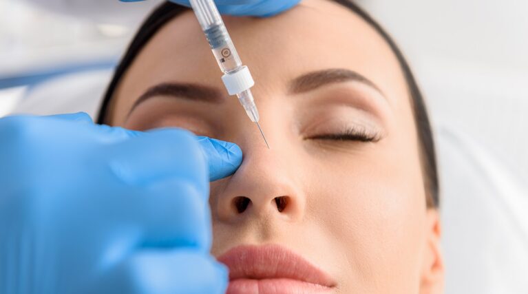 shutterstock_615013439 Woman has a non-surgical nose job or rhinoplasty to correct the shape of her nose