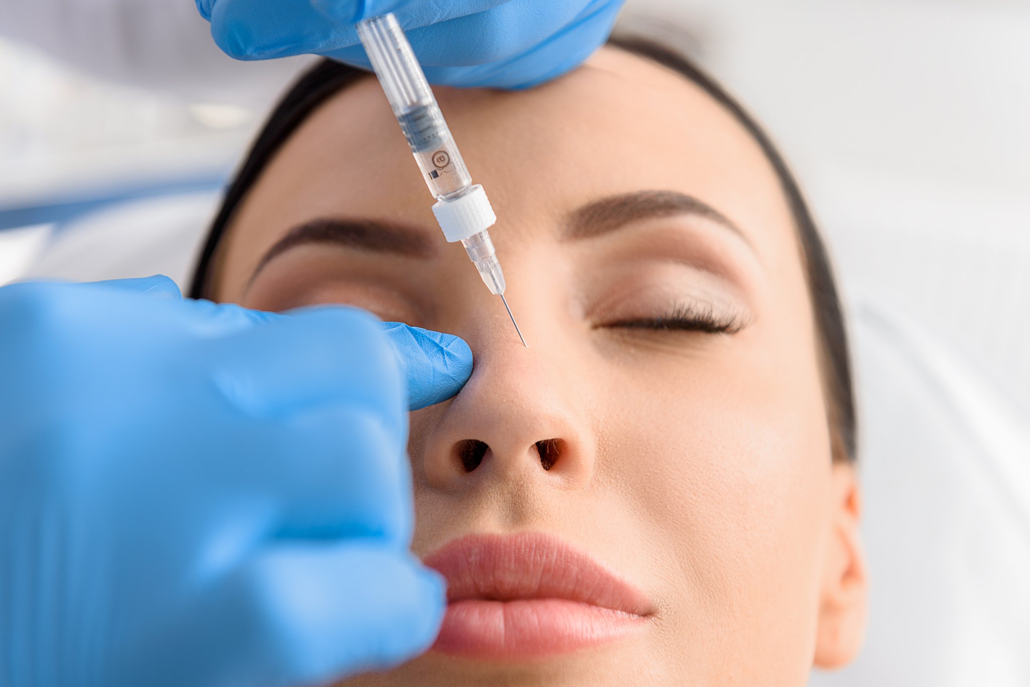 Woman has a non-surgical nose job or rhinoplasty to correct the shape of her nose